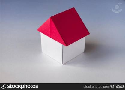 White and red paper house origami isolated on a blank background.. White and red paper house origami isolated on blank background