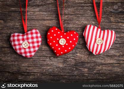 White and red sewed christmas hearts attached to the rope. Holiday background for greetings Valentine&rsquo;s day