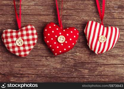 White and red sewed christmas hearts attached to the rope. Holiday background for greetings Valentine&amp;#39;s day