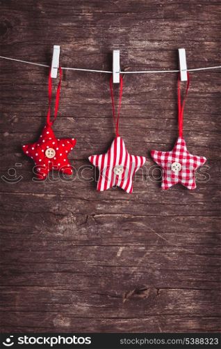 White and red sewed christmas stars attached to the rope