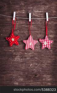 White and red sewed christmas stars attached to the rope