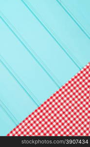 White and red towel over wooden kitchen table. View from above.