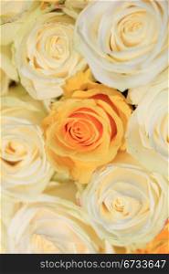 White and yellow roses in a wedding flower arrangement