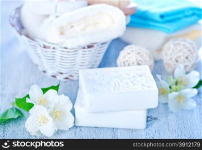 white aroma soap and flowers on a table