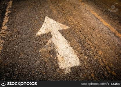 white arrow on road forward signs on old asphalt road texture background