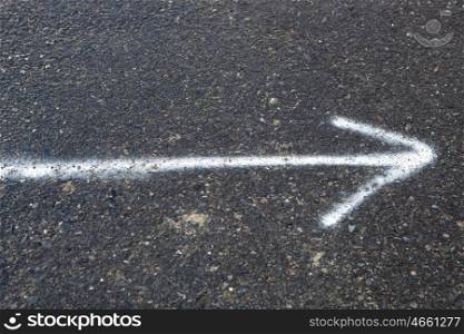 White arrow painted on the road pointing to the right