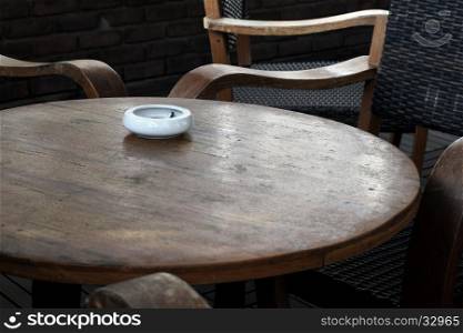 white ashtray on the old wooden table