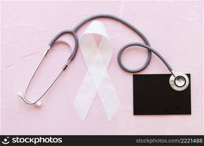 white awareness ribbons with stethoscope slate pink background