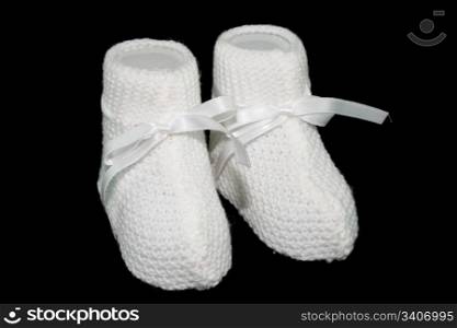 white baby socks with horizontal ties with black background