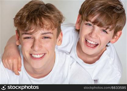 White background studio photograph of young happy boy children brothers smiling together