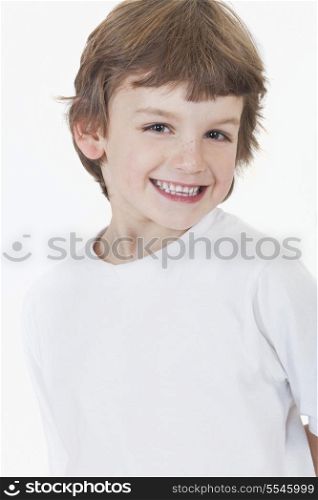 White background studio photograph of young happy boy smiling