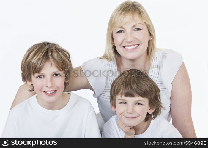 White background studio photograph of young happy family mother and two boy sons smiling