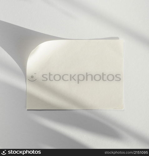 white background with white blank paper with its shadow