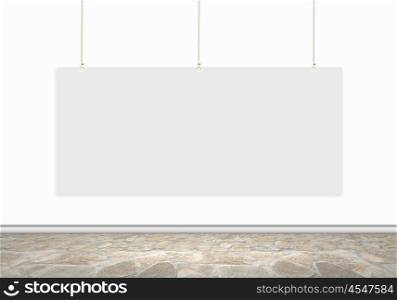White banner. Blank white banner hanging on wall. Place for text