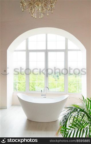 White bathroom with big window and bathtube. White bathroom