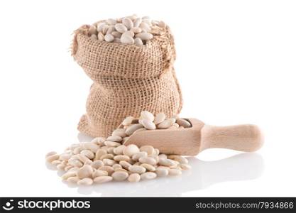 White beans bag with wooden scoop on white background.