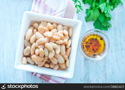 white beans in bowl and on a table