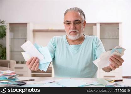 White bearded old man in budget planning concept 