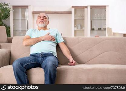 White bearded old man suffering at home