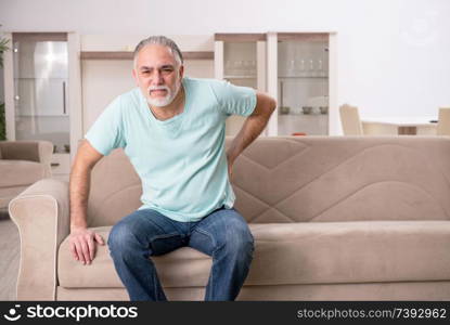 White bearded old man suffering at home