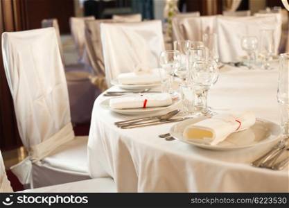 White beautiful table set for a wedding dinner. White wedding table set