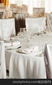 White beautiful table set for a wedding dinner. White wedding table set