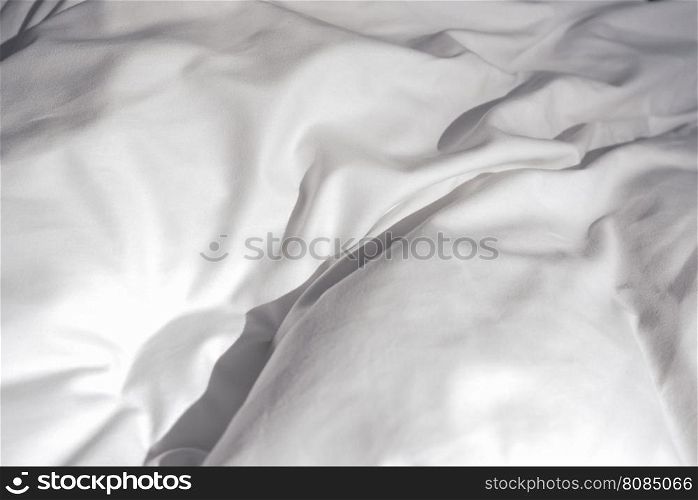 White bed sheets. Detail of white sheets on a bed