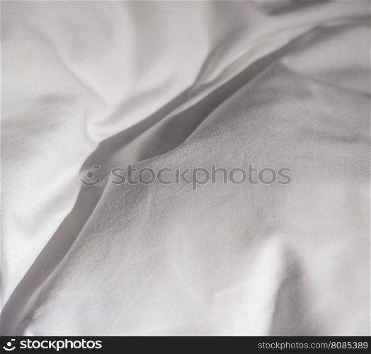 White bed sheets. Detail of white sheets on a bed