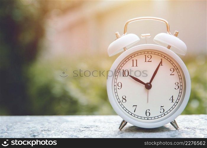white bell clock at outdoor garden background time around 10 o’clock in the morning