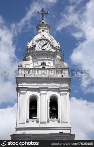 White bell tower with clock in Quito, Ecuador
