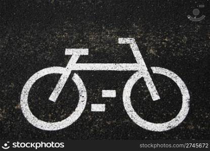 white bicycle road sign painted on the asphalt road