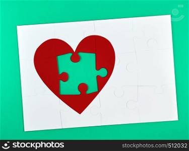 white big puzzles, one element from the red heart shape is missing, green background