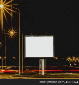 white billboard with traffic lights night