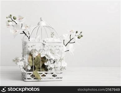 white bird cage full flowers
