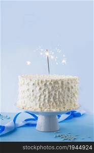 white birthday cake with burning sparkler. High resolution photo. white birthday cake with burning sparkler