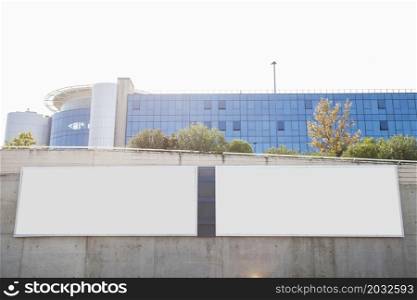 white blank billboards concrete wall front corporate building