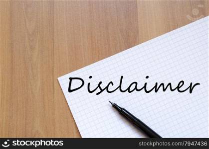 White blank notepad on office wooden table Disclaimer concept