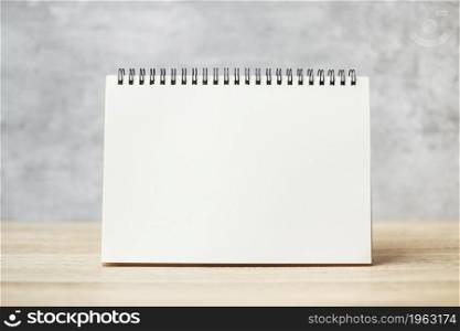 white blank paper notebook or Calendar on wooden table with Copy space for your text, template and mock up concept