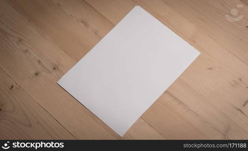 White blank paper notepad on wooden table.