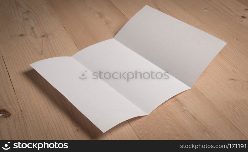 White blank paper notepad on wooden table.