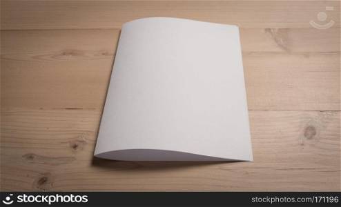 White blank paper notepad on wooden table.