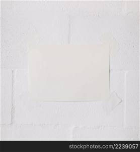 white blank paper stick with tape white wall backdrop