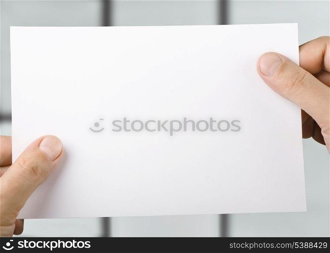 White blank sheet of paper in hands