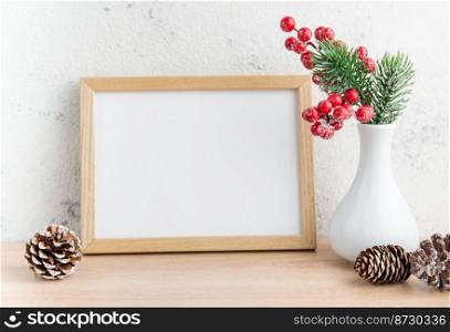 White blank wooden frame mockup with Christmas decorations  on the wooden table.  Frame for"es. Christmas postcard. 