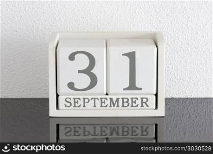 White block calendar present date 31 and month September. White block calendar present date 31 and month September on white wall background