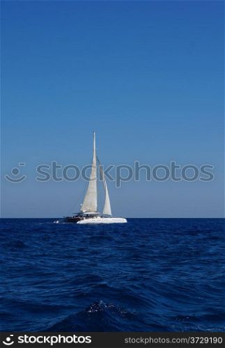 White boat with sails in the Mediterranean