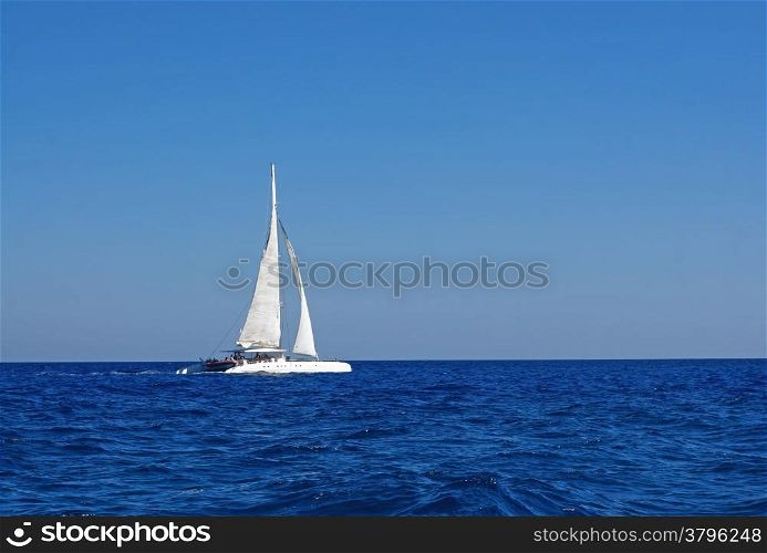 White boat with sails in the Mediterranean
