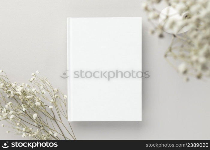 White book blank cover mockup on a beige background with dry flower, flat lay, mockup 