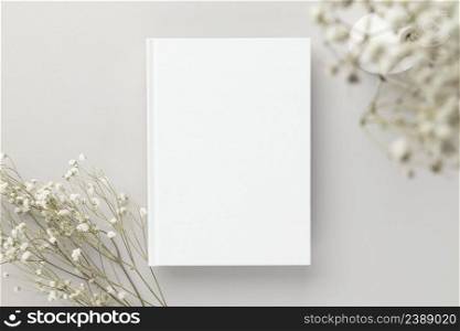 White book blank cover mockup on a beige background with dry flower, flat lay, mockup 