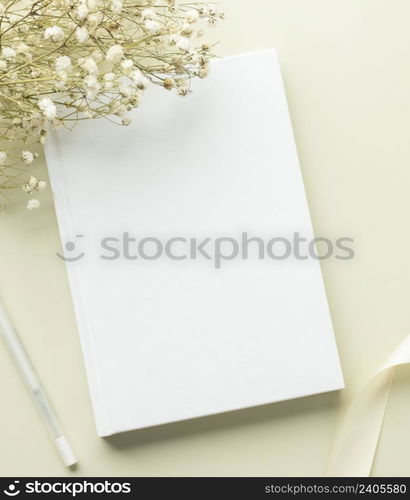 White book blank cover mockup on a beige background with dry flower, flat lay, mockup